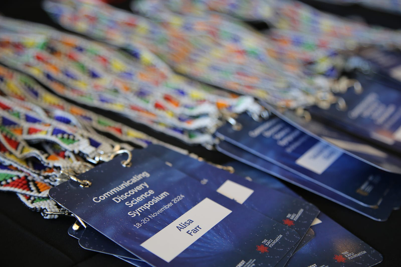 Delegates are ready for an inspiring start at the Communicating Discovery Science Symposium, with each nametag a symbol of their valuable contribution to the conversation on science communication.