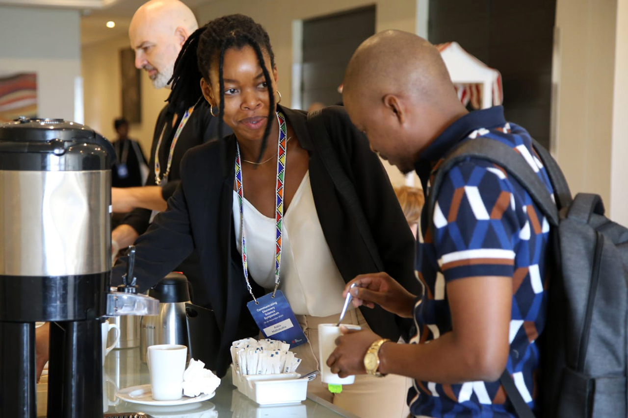 Delegates taking a moment to enjoy a coffee break, reconnecting and sharing insights during the session interlude.